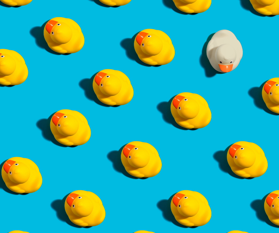 UCaaS Providers-Differentiate Yourself From The Big Brands-yellow ducks on blue background with one white duck facing the another direction