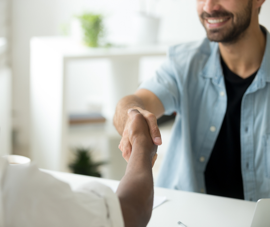 men discussing customer experience and shaking hands